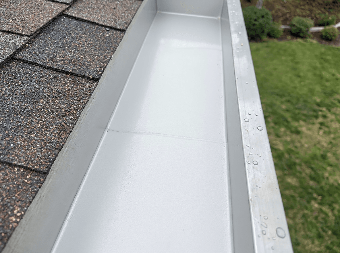 Freshly cleaned gutters flowing clear after a Brisk clean-out
